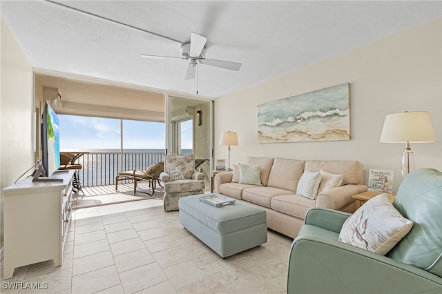 living room with ceiling fan and light tile patterned floors