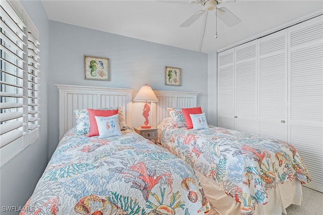 bedroom with a closet, ceiling fan, and carpet flooring