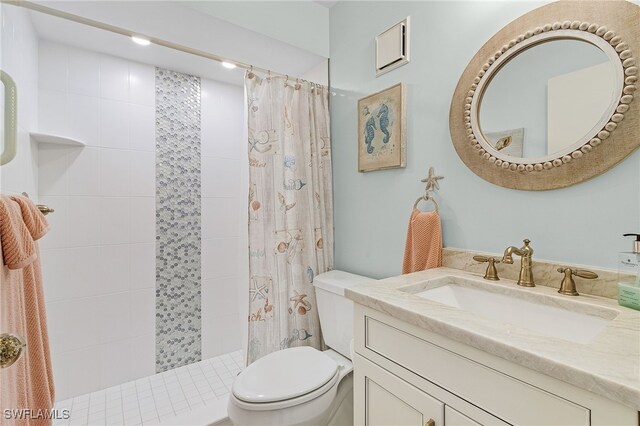 bathroom featuring toilet, a shower with curtain, and vanity