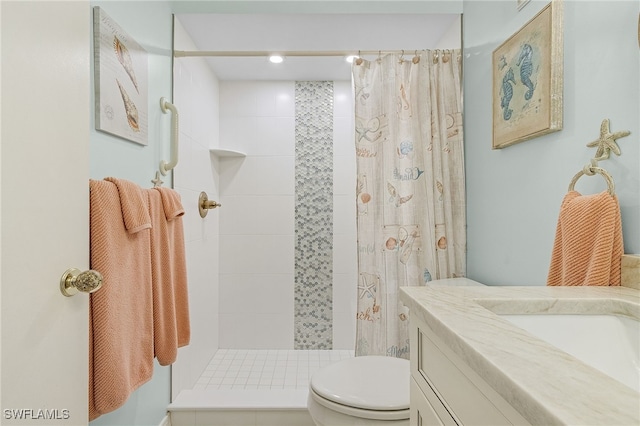 bathroom with toilet, curtained shower, and vanity