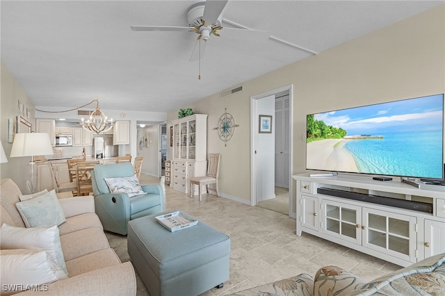 living room with ceiling fan with notable chandelier