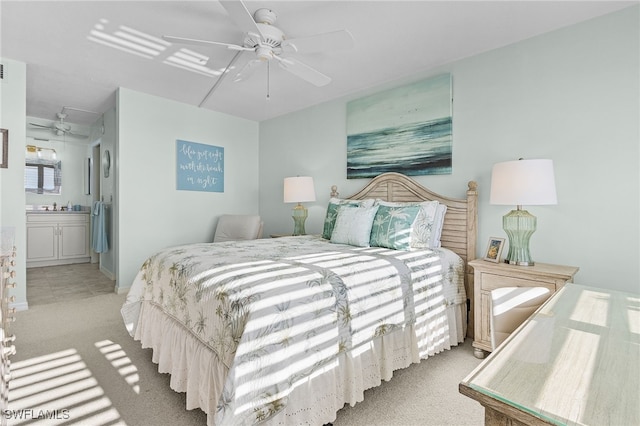 carpeted bedroom featuring connected bathroom, ceiling fan, and sink