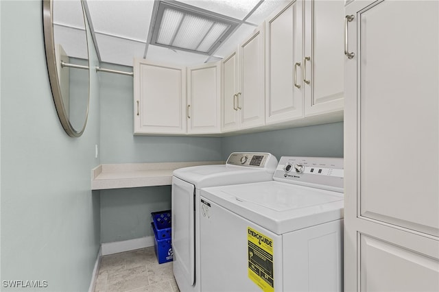 washroom featuring independent washer and dryer, cabinets, and light tile patterned floors