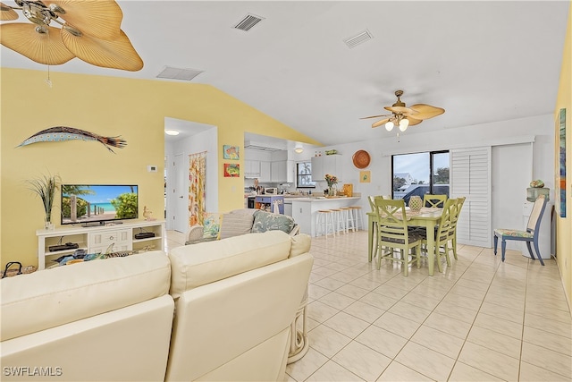 tiled living room featuring ceiling fan and vaulted ceiling