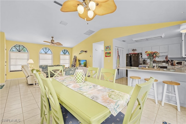 dining area with light tile patterned floors, ceiling fan, and lofted ceiling