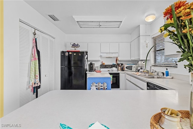 kitchen featuring kitchen peninsula, sink, white cabinets, and black appliances