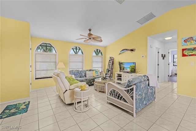 living room with ceiling fan, light tile patterned floors, and lofted ceiling