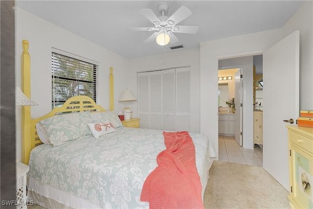 bedroom with ceiling fan, a closet, and light colored carpet