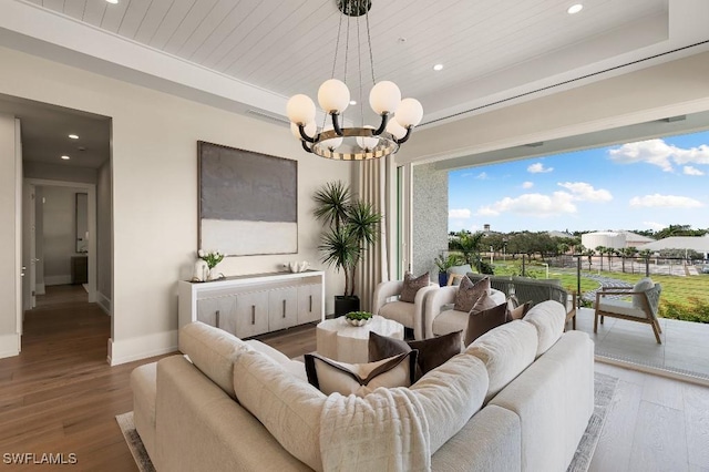 living room featuring wood ceiling, wood-type flooring, and a notable chandelier