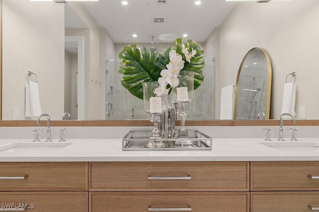 bathroom with vanity and a shower with shower door