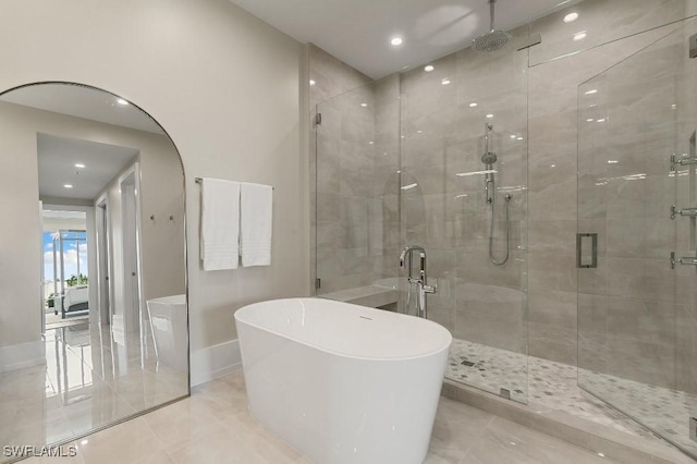 bathroom with shower with separate bathtub and tile patterned floors