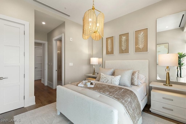 bedroom featuring a notable chandelier and wood-type flooring