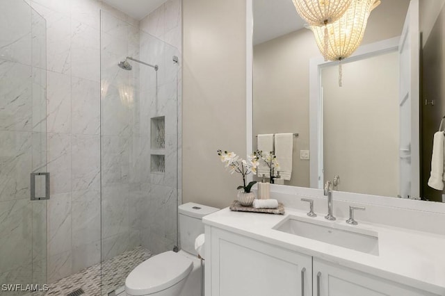 bathroom with an enclosed shower, vanity, toilet, and an inviting chandelier