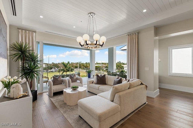 living room featuring wooden ceiling, dark wood-type flooring, and a chandelier