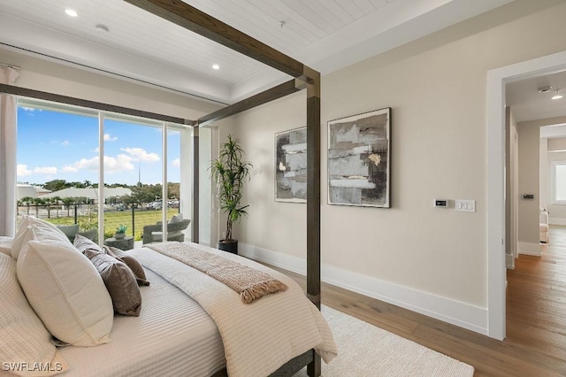 bedroom with hardwood / wood-style floors, beam ceiling, access to exterior, and wood ceiling