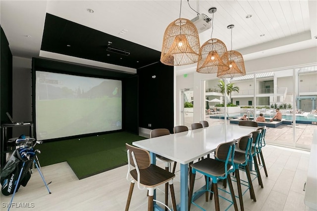 dining space with golf simulator and wood ceiling