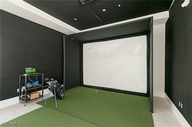 game room featuring golf simulator and light hardwood / wood-style floors