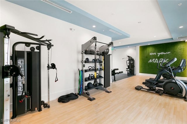 workout area with hardwood / wood-style floors