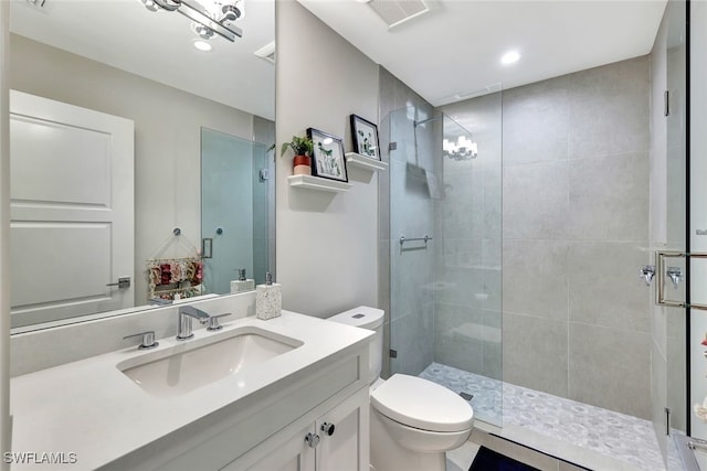 bathroom with vanity, toilet, and walk in shower