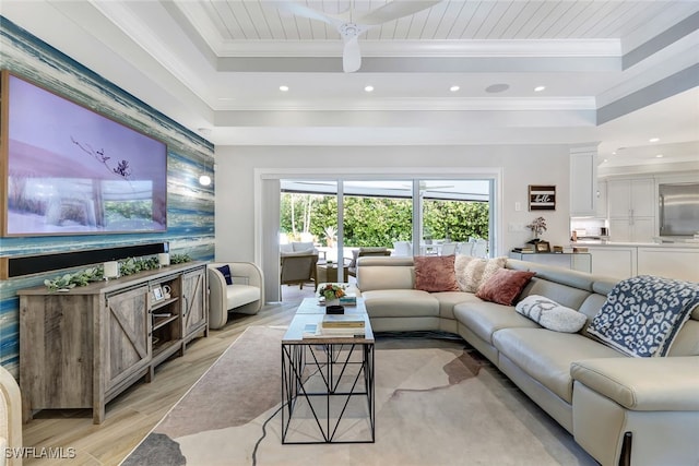 living room with crown molding, light hardwood / wood-style flooring, wood ceiling, and a tray ceiling