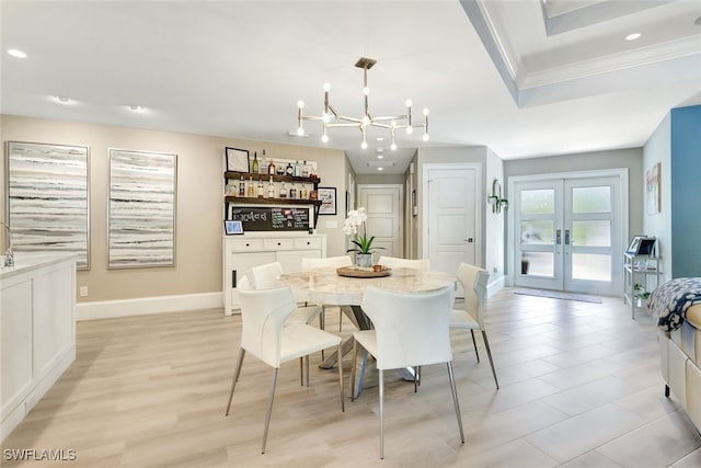 dining space featuring french doors, light hardwood / wood-style flooring, and a chandelier