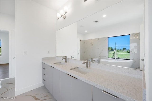 bathroom with vanity and a bathtub