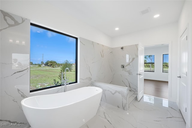 bathroom with separate shower and tub