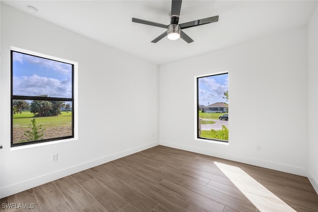 empty room with ceiling fan and hardwood / wood-style floors