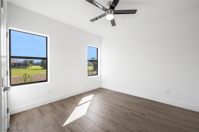 unfurnished room with hardwood / wood-style flooring, a wealth of natural light, and ceiling fan