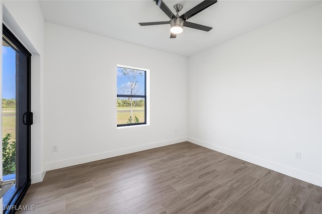 spare room with ceiling fan and wood-type flooring