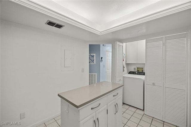 laundry room featuring washer / dryer, electric panel, light tile patterned floors, and cabinets