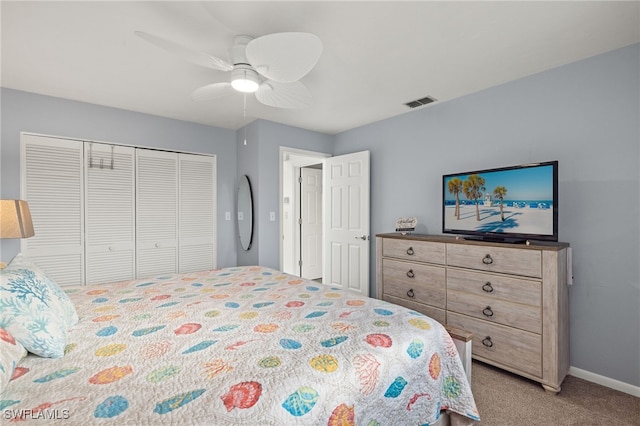 carpeted bedroom featuring ceiling fan and a closet