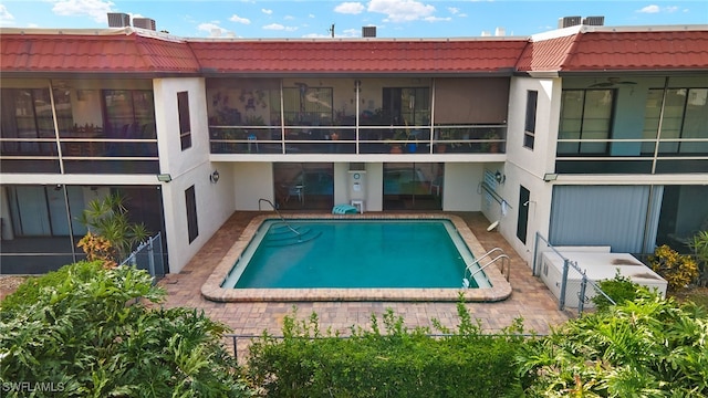 4728 Orange Grove Blvd Unit 8, North Fort Myers, FL 33903 - back of house featuring stucco siding, a tiled roof, an outdoor pool, and a patio area