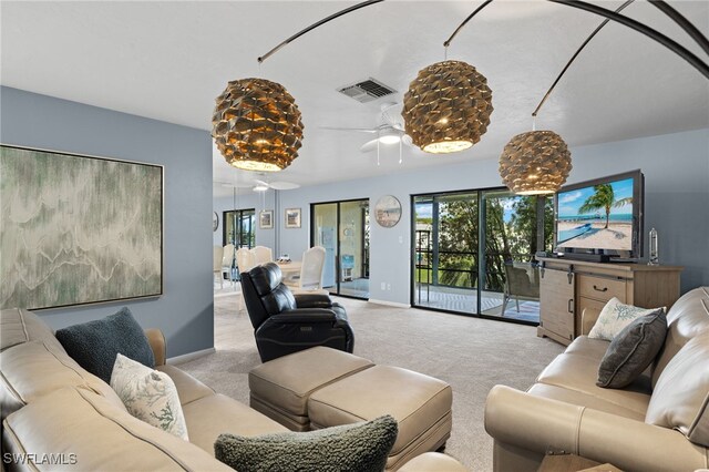 living room with ceiling fan and light carpet