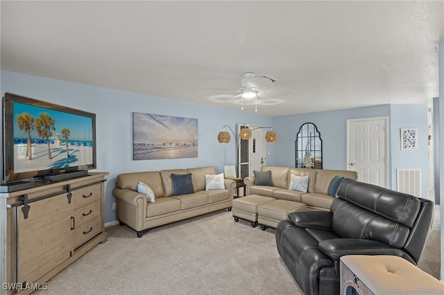 carpeted living room with ceiling fan