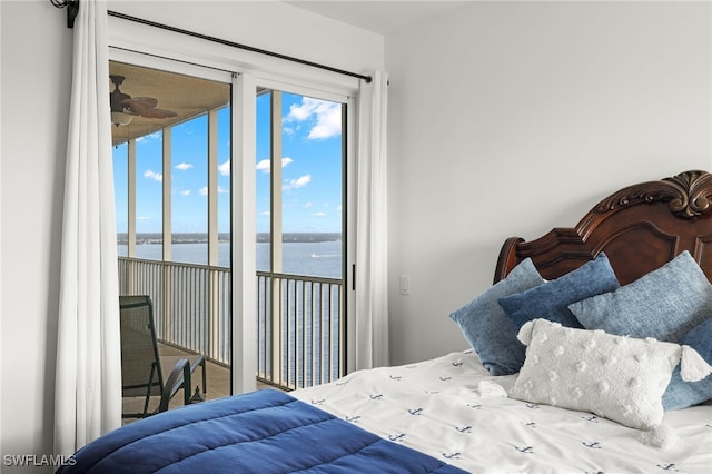 bedroom featuring a water view and access to exterior