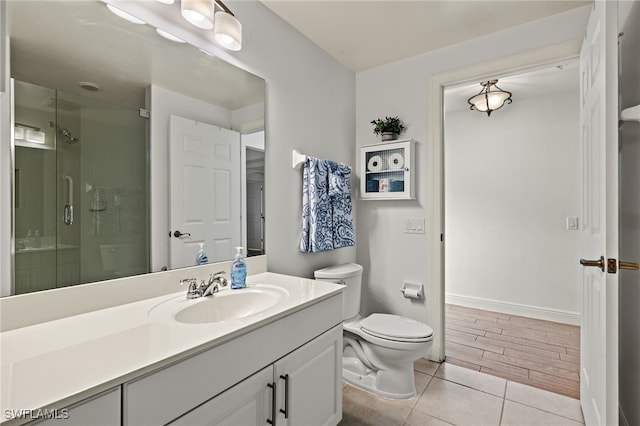 bathroom with vanity, toilet, hardwood / wood-style flooring, and walk in shower