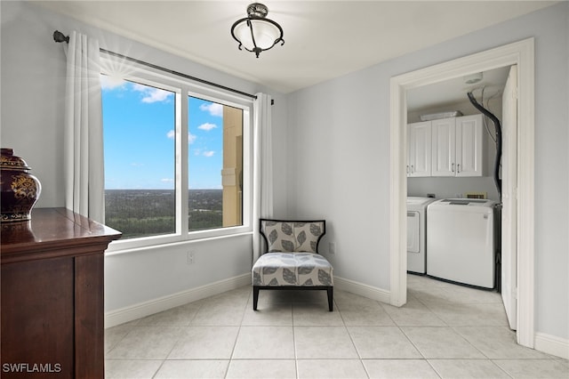 sitting room featuring light tile patterned flooring and separate washer and dryer