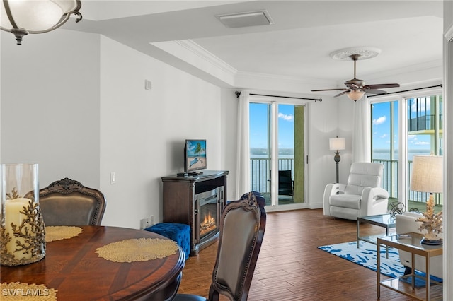 dining area featuring ornamental molding, ceiling fan, and dark hardwood / wood-style flooring