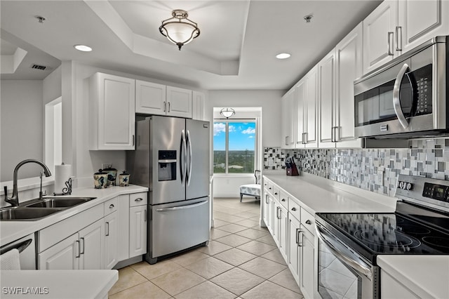 2745 1st St Unit 1906, Fort Myers, FL 33916 - kitchen with stainless steel appliances, a sink, white cabinets, recessed lighting, and light tile patterned floors