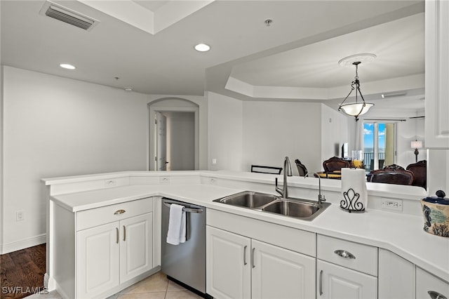 kitchen featuring kitchen peninsula, white cabinetry, dishwasher, pendant lighting, and sink