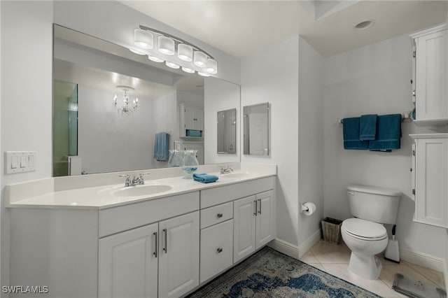 bathroom with vanity, toilet, a chandelier, and tile patterned flooring