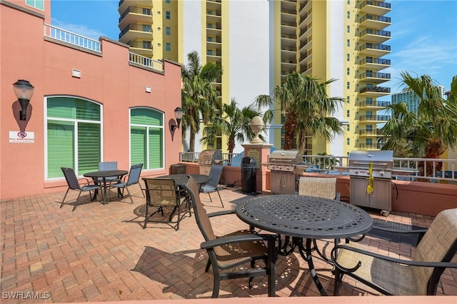 view of patio / terrace featuring area for grilling, a balcony, and an outdoor kitchen