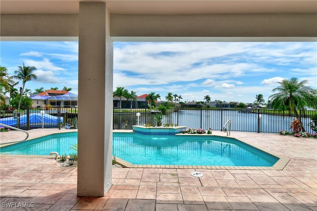 view of swimming pool with a patio and a water view