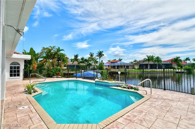 view of pool featuring a patio and a water view