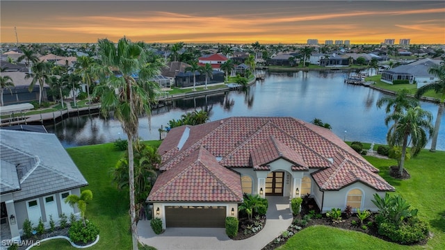 aerial view at dusk with a water view