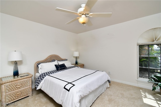 bedroom featuring light carpet and ceiling fan