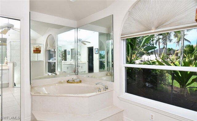 bathroom with plus walk in shower, tile patterned flooring, and ceiling fan