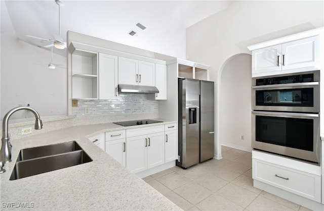 kitchen with stainless steel appliances, white cabinets, sink, and light stone counters