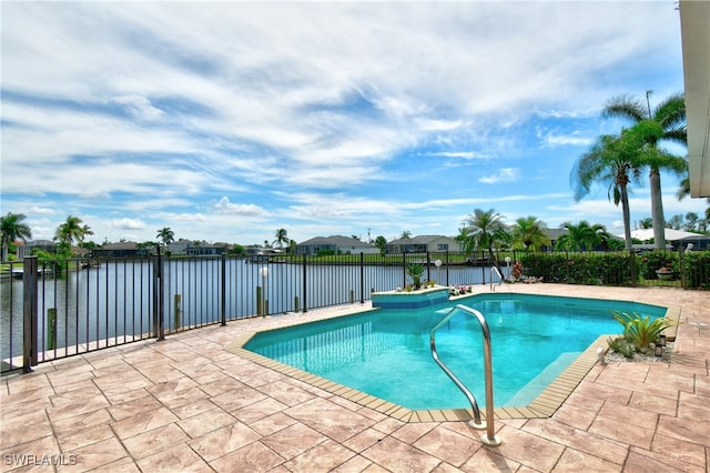 view of pool with a patio and a water view